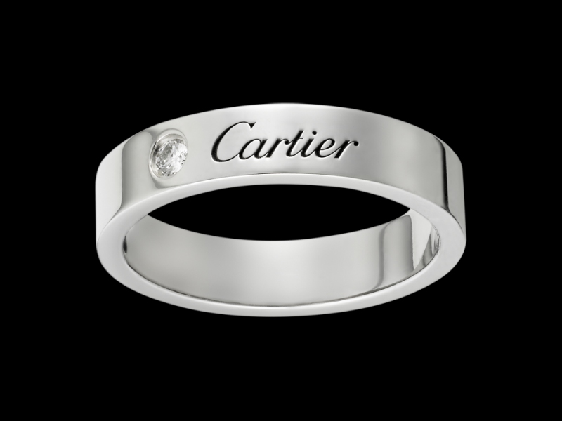 Cartier- Alliance Gravée A simple platinum engraved Cartier wedding band with a diamond set next to the brand name. (~ 2'960 Euros)