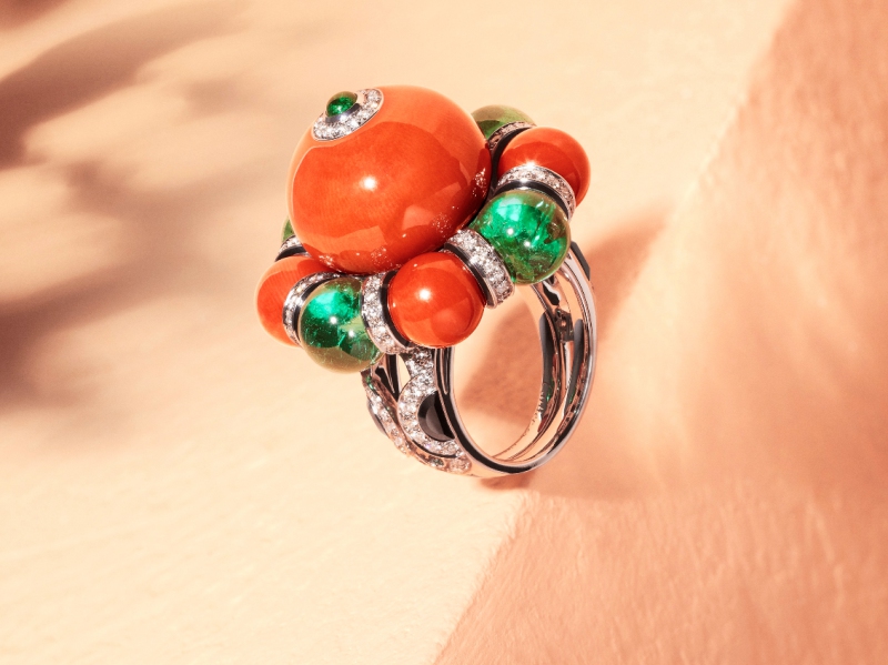 Cartier Flamboyant Ring - Set in platinum, one 30.19-carat coral bead, four coral beads totalling 13.47 carats, four emerald beads from Zambia totalling 14.28 carats, cabochon-cut emerald, onyx, black lacquer, brilliant- cut diamonds. Etourdissant Collection