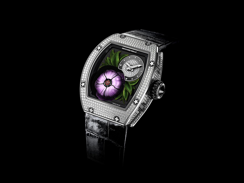 Audemars Piguet  The Millenary Tourbillon with the off-centered fully diamond paved flower and a transparency of the case allowing the whole appearing mechanism to breathe.