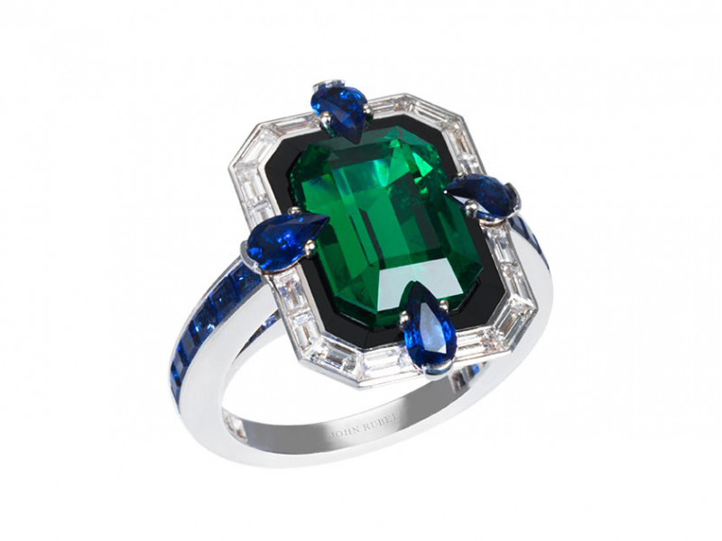 John Rubel Liberty ring mounted on grey gold with emerald, diamonds, sapphire and ony. This ring is available at the Pop Up