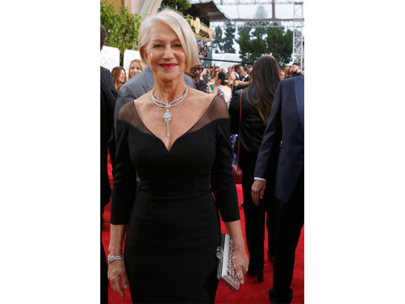 Helen Mirren Wears Harry Winston's Secret collection with a Secret Cluster Diamond Necklace set with 83.72 carats of diamonds on platinum; a Secret Cluster Diamond Bracelet of 19.58 carats and Winston Cluster Diamond Earrings worth 12 carats.